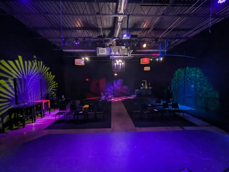 Preshow look in purple with yellow and green gobo patterns on the walls