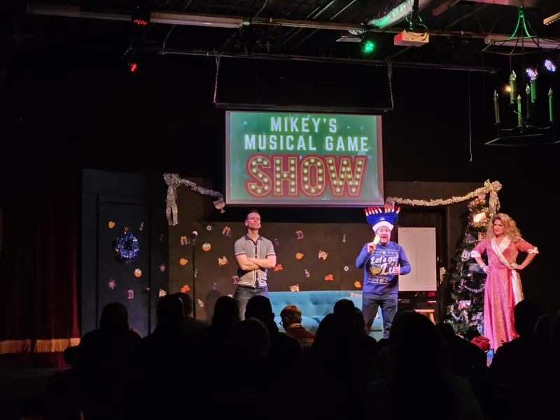 Mikey's Musical Game Show in full holiday color with the audience silhouetted in front