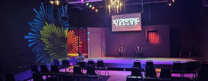 Panorama of the theater with gobo-textured color on the walls and a magenta stage edge