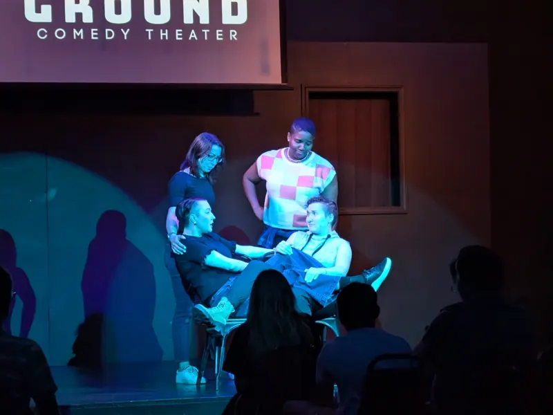 Scene in cyan and amber with sharp shadows thrown across the upstage wall